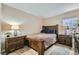 Cozy bedroom featuring carpeted floors, neutral paint, and a lovely wood frame bed set at 7224 Piute Mesa St, North Las Vegas, NV 89084