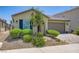 Well-kept single-story home with an arched entryway, tile roof, and desert landscaping at 7224 Piute Mesa St, North Las Vegas, NV 89084