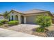 Inviting single-story home with a tile roof, arched entry, and desert landscaping at 7224 Piute Mesa St, North Las Vegas, NV 89084