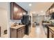 Stylish kitchen boasts granite counters, dark cabinets, and views into the living room at 7224 Piute Mesa St, North Las Vegas, NV 89084