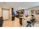 Modern kitchen with granite countertops, stainless steel appliances, and breakfast bar at 7224 Piute Mesa St, North Las Vegas, NV 89084