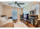 Cozy living room area featuring tile flooring, neutral paint, and ceiling fan at 7224 Piute Mesa St, North Las Vegas, NV 89084