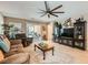 Cozy living room featuring tile floors, ceiling fan, and sliding glass doors at 7224 Piute Mesa St, North Las Vegas, NV 89084