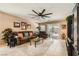 Comfortable living room with tile flooring, ceiling fan, and sliding glass doors at 7224 Piute Mesa St, North Las Vegas, NV 89084