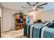 Neutral bedroom boasting carpeted floors, a large fan, and media center at 7224 Piute Mesa St, North Las Vegas, NV 89084