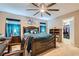 Bedroom featuring a large ceiling fan, neutral paint, carpet floors, and closet access at 7224 Piute Mesa St, North Las Vegas, NV 89084