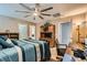 Main bedroom offers spacious layout with desk area, large fan, and carpet flooring at 7224 Piute Mesa St, North Las Vegas, NV 89084