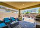 Relaxing covered patio with outdoor seating and decorative water feature, perfect for entertaining guests at 7224 Piute Mesa St, North Las Vegas, NV 89084