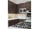 Close-up of a modern kitchen with stainless steel appliances and a gas cooktop at 80 Glade Hollow Dr, Las Vegas, NV 89135