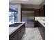 Gourmet kitchen featuring stainless steel appliances, dark wood cabinets, and a gas range cooktop at 80 Glade Hollow Dr, Las Vegas, NV 89135