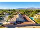 Attractive aerial view of a well-maintained home featuring a spacious backyard, mature trees, and mountain views at 8650 W Verde Way, Las Vegas, NV 89149