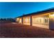 Exterior view of a home with a covered patio, solar panels, and a spacious desert landscape yard at 8650 W Verde Way, Las Vegas, NV 89149