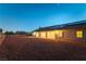 Home exterior showcasing solar panels, a covered patio, and a low-maintenance desert rock yard at 8650 W Verde Way, Las Vegas, NV 89149