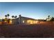 Expansive backyard featuring desert landscaping, a covered patio, and solar panels on the roof at 8650 W Verde Way, Las Vegas, NV 89149