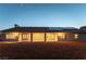 Rear view of a house with desert landscaping, covered patio, solar panels, and a block wall fence at 8650 W Verde Way, Las Vegas, NV 89149