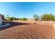 Spacious backyard featuring a large gravel area and privacy wall, perfect for outdoor living and entertaining at 8650 W Verde Way, Las Vegas, NV 89149