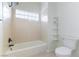 Cozy bathroom with a shower and tub combination and a small window at 8650 W Verde Way, Las Vegas, NV 89149