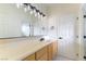 Bathroom with an extended vanity and light fixtures above the large mirror at 8650 W Verde Way, Las Vegas, NV 89149