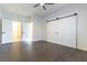 Bedroom with ceiling fan, wood-look flooring, sliding closet doors and a bathroom entrance at 8650 W Verde Way, Las Vegas, NV 89149
