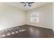 Bedroom featuring hardwood floors and a window with fan-shaped shutters at 8650 W Verde Way, Las Vegas, NV 89149