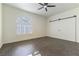 Bedroom features ceiling fan, wood-look flooring, window with shutters and sliding closet doors at 8650 W Verde Way, Las Vegas, NV 89149
