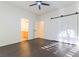 Bright bedroom features a ceiling fan, wood-look flooring, and sliding closet doors at 8650 W Verde Way, Las Vegas, NV 89149