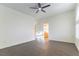 Bedroom with ceiling fan, wood-look flooring, and a bathroom entrance at 8650 W Verde Way, Las Vegas, NV 89149