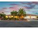 Charming single-story home featuring a well-manicured front yard, mature landscaping, and a three-car garage at 8650 W Verde Way, Las Vegas, NV 89149