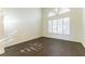Spacious living room features hardwood floors, natural light, and a large window with fan-shaped shutters at 8650 W Verde Way, Las Vegas, NV 89149
