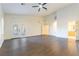 Living room with wood-look flooring and multiple entrances to other rooms at 8650 W Verde Way, Las Vegas, NV 89149