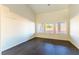 Bright room with hardwood floors and three windows offer views of the exterior at 8650 W Verde Way, Las Vegas, NV 89149