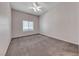 Bright bedroom with neutral carpet, ceiling fan, and window at 8805 Jeffreys St # 1048, Las Vegas, NV 89123
