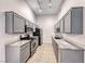 Galley kitchen featuring gray cabinets, granite countertops, and stainless steel appliances at 8805 Jeffreys St # 1048, Las Vegas, NV 89123