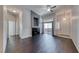 Spacious living room with dark hardwood floors, modern fireplace, and sliding glass door at 8805 Jeffreys St # 1048, Las Vegas, NV 89123