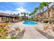 Community pool surrounded by swaying palm trees and comfortable lounge chairs at 8805 Jeffreys St # 1048, Las Vegas, NV 89123