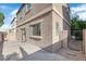 This backyard boasts a wood deck, gravel landscaping, stucco exterior, and a metal gate at 9024 Hazy Haven Ct, Las Vegas, NV 89149