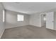 Bright bedroom with a window and access to the hallway, featuring neutral-toned walls and carpet at 9024 Hazy Haven Ct, Las Vegas, NV 89149