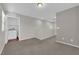 Relaxing bonus room offers neutral paint, carpet, recessed lighting, and a hallway with a laundry room at 9024 Hazy Haven Ct, Las Vegas, NV 89149