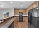 Modern kitchen with stainless steel appliances, granite countertops, and wood cabinets at 9024 Hazy Haven Ct, Las Vegas, NV 89149