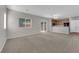 Open-concept living room with carpet and a sliding glass door to the backyard at 9024 Hazy Haven Ct, Las Vegas, NV 89149
