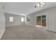 Living room with neutral walls, carpet, and sliding glass doors to the patio at 9024 Hazy Haven Ct, Las Vegas, NV 89149
