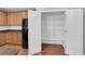 Open pantry with multiple shelves, adjacent to the refrigerator and kitchen cabinetry at 9024 Hazy Haven Ct, Las Vegas, NV 89149