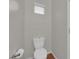 Toilet with white tank and toilet paper holder, complemented by wood-look flooring at 9024 Hazy Haven Ct, Las Vegas, NV 89149