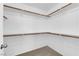Walk-in closet with wood rods for hanging clothes and neutral carpet at 9024 Hazy Haven Ct, Las Vegas, NV 89149