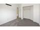 Bright bedroom with neutral carpet, and an open closet, providing a simple and inviting space at 925 Mandolin Way, North Las Vegas, NV 89032