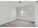 Bright bedroom with a neutral carpet, window, and white walls, creating a clean and serene living space at 925 Mandolin Way, North Las Vegas, NV 89032
