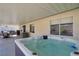 Relaxing hot tub under a covered patio with a view of the manicured backyard and outdoor seating area at 925 Mandolin Way, North Las Vegas, NV 89032
