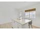 Bright kitchen featuring white cabinets, stainless steel appliances, and a marble countertop island with seating at 925 Mandolin Way, North Las Vegas, NV 89032