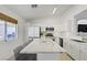 Modern kitchen with white cabinets, stainless steel appliances, and a marble island at 925 Mandolin Way, North Las Vegas, NV 89032