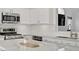 Modern kitchen with white cabinets, stainless steel appliances, and a marble island at 925 Mandolin Way, North Las Vegas, NV 89032